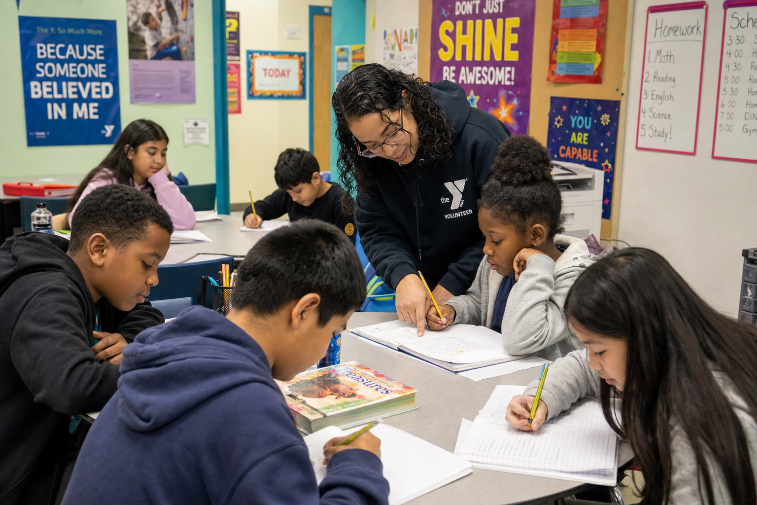 A volunteer teacher helps a diverse group of children with homework at an after-school program, showing engaged learning in a bright, supportive classroom setting